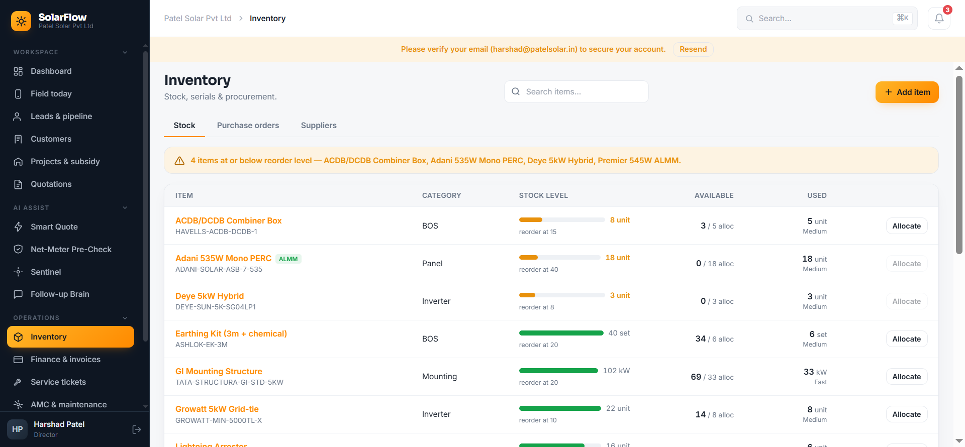 SolarFlow's inventory screen, showing stock levels for panels, inverters, and BOS components with ALMM tags and reorder alerts